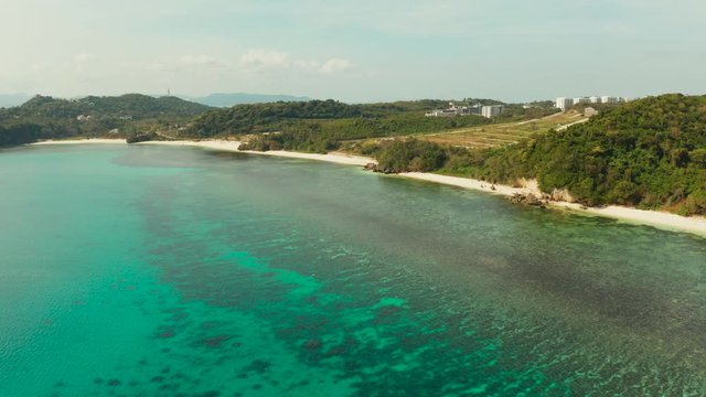 Tropical sandy beach near the blue lagoon and corall reef, aerial view Boracay, Philippines. Ilig Iligan Beach. Summer and travel vacation concept.