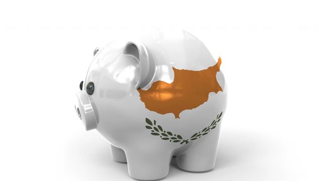 Coins fall into piggy bank painted with flag of Cyprus. National banking system or savings related conceptual 3D animation