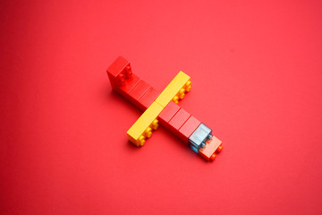 children's plastic bricks or blocks toy with an aeroplane design on red background