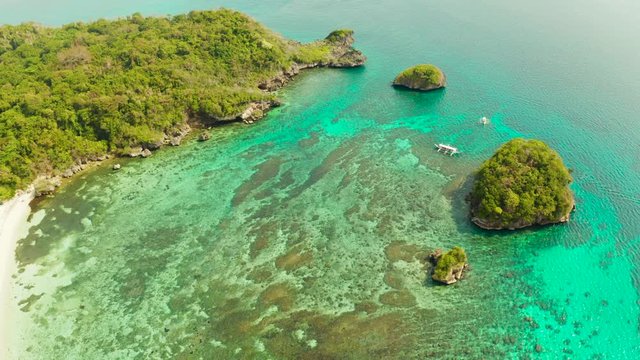 Turquoise lagoon with rocky island and corall reef, aerial view Boracay, Philippines. Summer and travel vacation concept.
