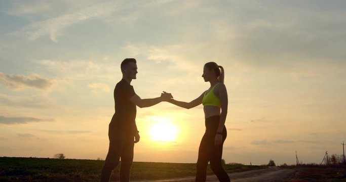 Man and girl are shaking hands after the race in autumn weather 4K 