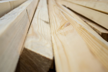 Wood, timber, construction material stacked in warehouse. For background and texture. close-up.