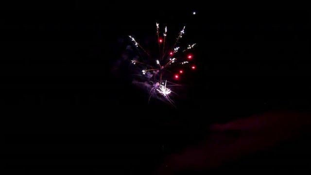 Red firework element on black background night to create video about salute on holiday and pyrotechnics happy New Year, Christmas, birthday greetings.