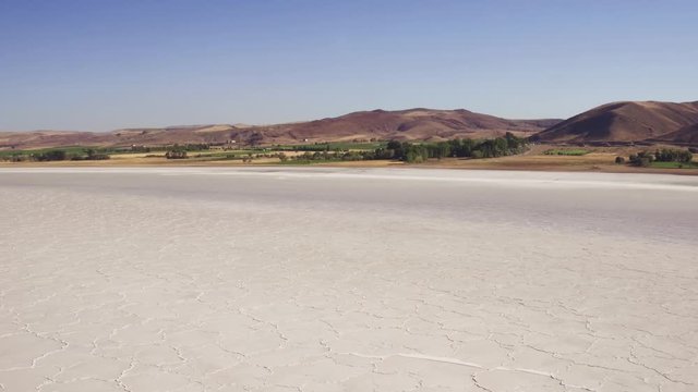 Large salt lake / Big Saline Lake in turkish dry mountains landscape / Summer sunny hot day at cloudless sky