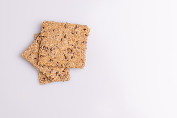 Diet flax seed whole grain crackers isolated on white background, soft light, copy space