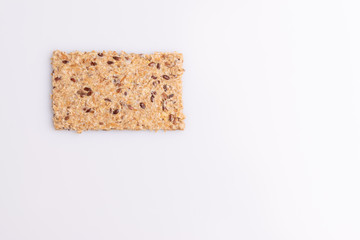 Diet flax seed whole grain crackers isolated on white background, soft light, copy space