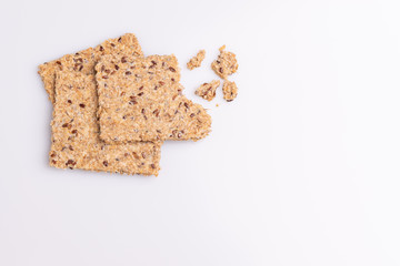 Diet flax seed whole grain crackers isolated on white background, soft light, copy space