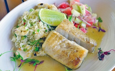 Healthy dish of grilled fish with fresh fruit salsa