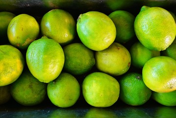 Crate of green limes at a farmers market