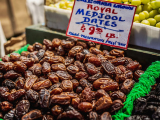 Farmer's market produce of fresh fres dates laid out in a pile for sale.