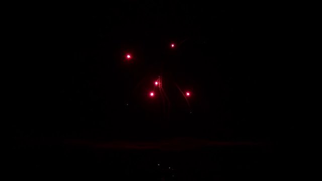 Explosion of bright colorful part of fireworks on black background to create a set salute on video for holiday new year, birthday, wedding or other celebration.