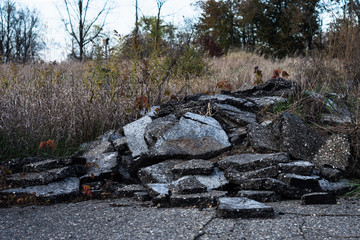 Broken asphalt pile on farmland