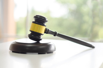 judge gavel on white table with blurred background