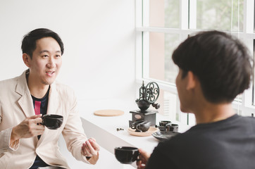 A group of Young business drink a coffee talking and brainstorm to forward plan business model in coffee bar