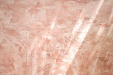 Fototapeta premium Tuscany wall. Terracotta brown colored wall plaster stained texture background with crack on the wall and soft sun light.