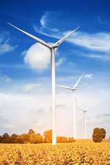 Wind turbine is alternative electrical power with blue sky, summer field, renewable energy