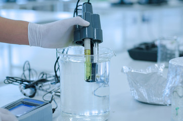 scientist used chemical solution and lab testing for water quality or ph meter in laboratory...
