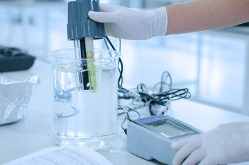 scientist used chemical solution and lab testing for water quality or ph meter in laboratory ,research and science concept