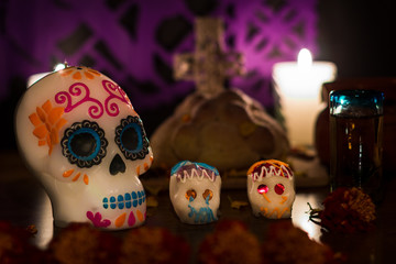 sugar skull candle with two little sugar skulls.