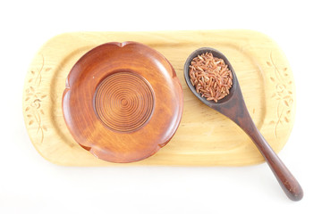 red rice in wooden spoon