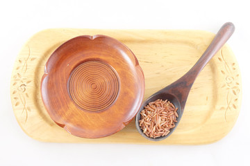 red rice in wooden spoon