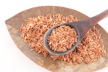 red rice in wooden spoon