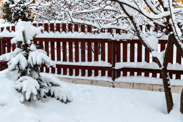 Fresh fluffy snow in the backyard of a rural house.