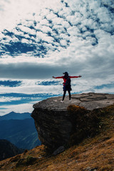 Girl on top of mountain