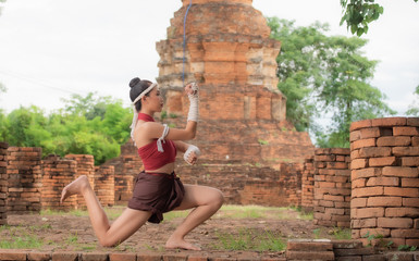 Young Thai warrior woman with Muay Thai (Thai Boxing) in old style fantasy dress.