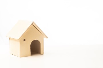 Miniature wooden house with black chalkboard isolated against white background for copy space