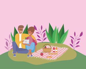 couple with tablet with food blanket picnic outdoor