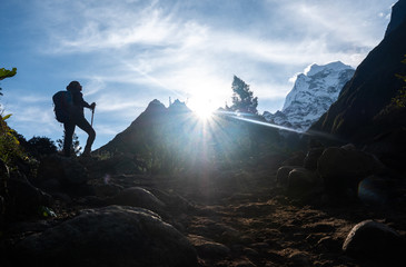 Active hiker hiking, enjoying the view, looking at Himalaya mountains landscape. Travel sport lifestyle concept