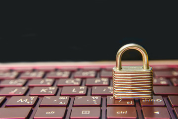The silver padlock on keyboard laptop. The computer is cyber security.