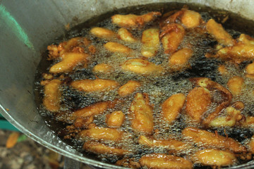 Bananas frying in pan with hot oil. Thai Snack.