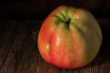 Textured ripe apple on old wood