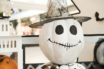 In the foreground is a white scarecrow of Halloween in the decoration of the decorated mix of unique shops, one-of-a-kind restaurants and lively entertainmen