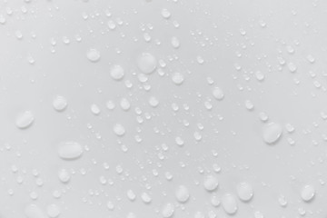 Raindrops on a grayish white background. Rainy season concept.