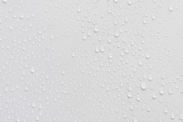 Raindrops on a grayish white background. Rainy season concept.