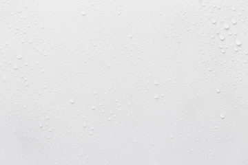 Raindrops on a grayish white background. Rainy season concept.