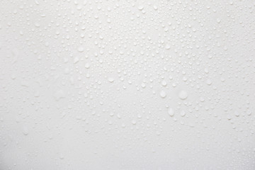 Raindrops on a grayish white background. Rainy season concept.