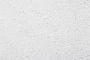Raindrops on a grayish white background. Rainy season concept.