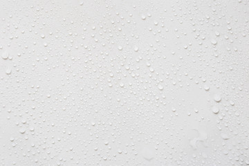 Raindrops on a grayish white background. Rainy season concept.
