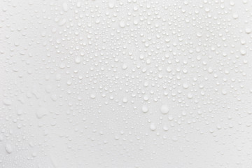 Raindrops on a grayish white background. Rainy season concept.