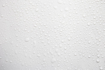 Raindrops on a grayish white background. Rainy season concept.