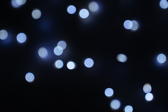 Defocused abstract blue christmas bokeh background copy space