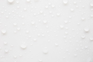 Raindrops on a grayish white background. Rainy season concept.