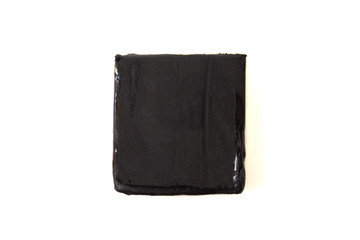 Black plasticine isolated on white background.