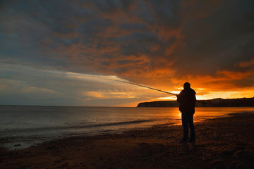 Fly fishing at sunset on the Jurassic Coast in Devon