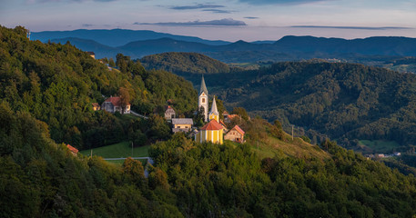 Fototapeta na wymiar Panoramic landscape with two churches in small village Zusem in Stajerska (Styria), Slovenia