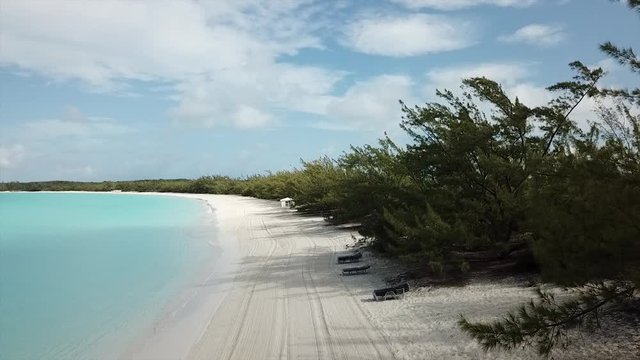Slow drone footage from sandy beach up to bluse sky one beautiful sandy beach on Bahamas island Half Moon Cay
